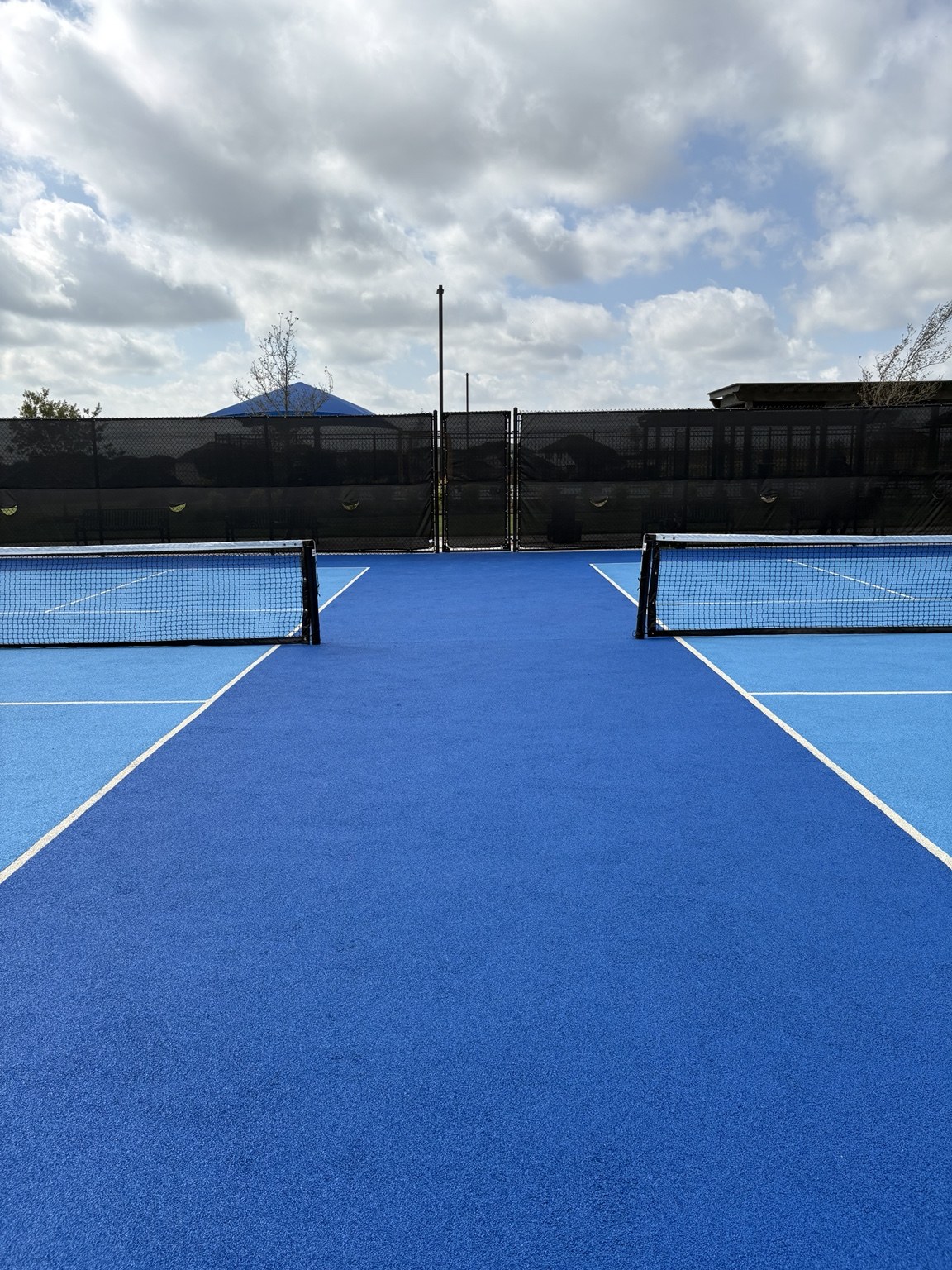 Close view of textured blue rubber court surfacing