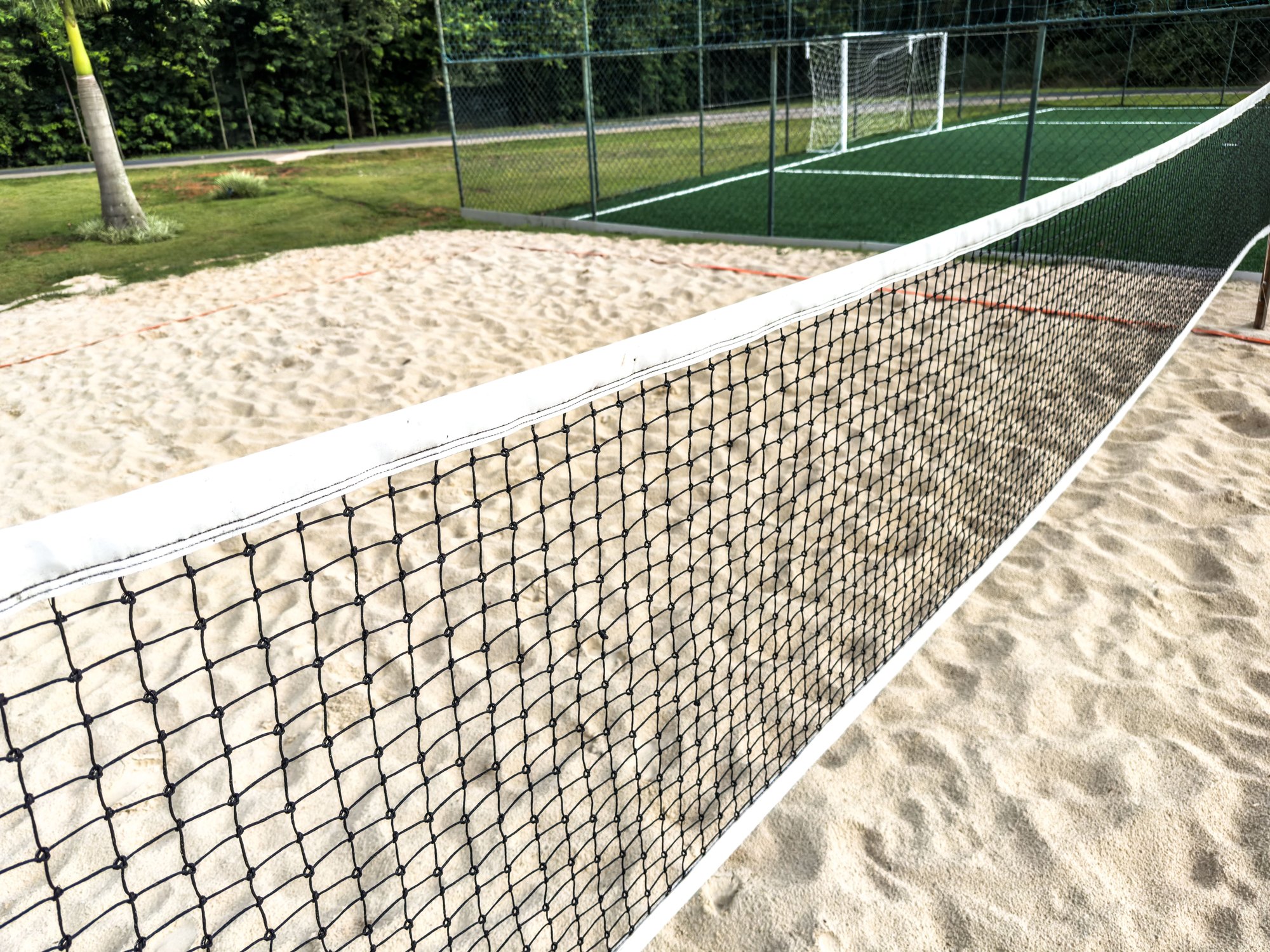 Sand volleyball court with posts and net